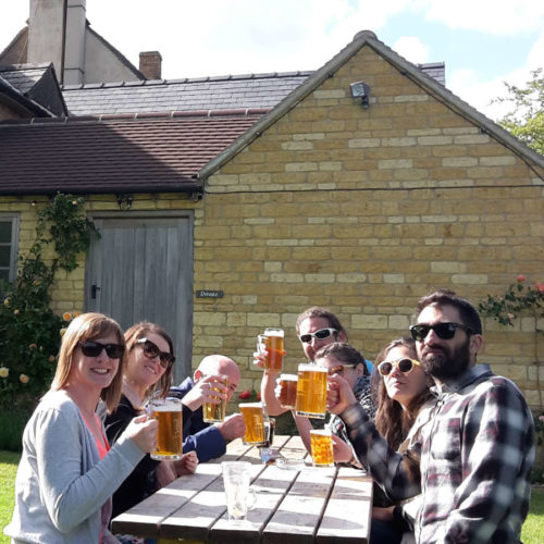 A group enjoying the beer garden at The Ebrington Arms on a Go Cotswolds pub tour