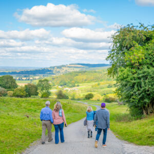 Guests walking through the Cotswolds on a Go Cotswolds tour