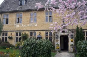 Blossom tree in bloom outside a Cotswolds stone pub in April
