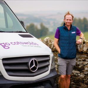 Tom standing by a minibus ready for car free care free cotswolds