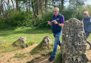 Martin trying dowsing on our Secret Cotswolds tour at the Rollright stones