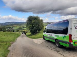 How to be a good tourist with Go Cotswolds. Picture of a minbus parked in a beautiful lane