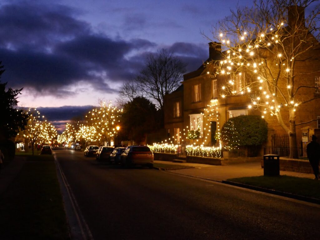 Beautiful christmas lights shining on a Cotswolds street in December.